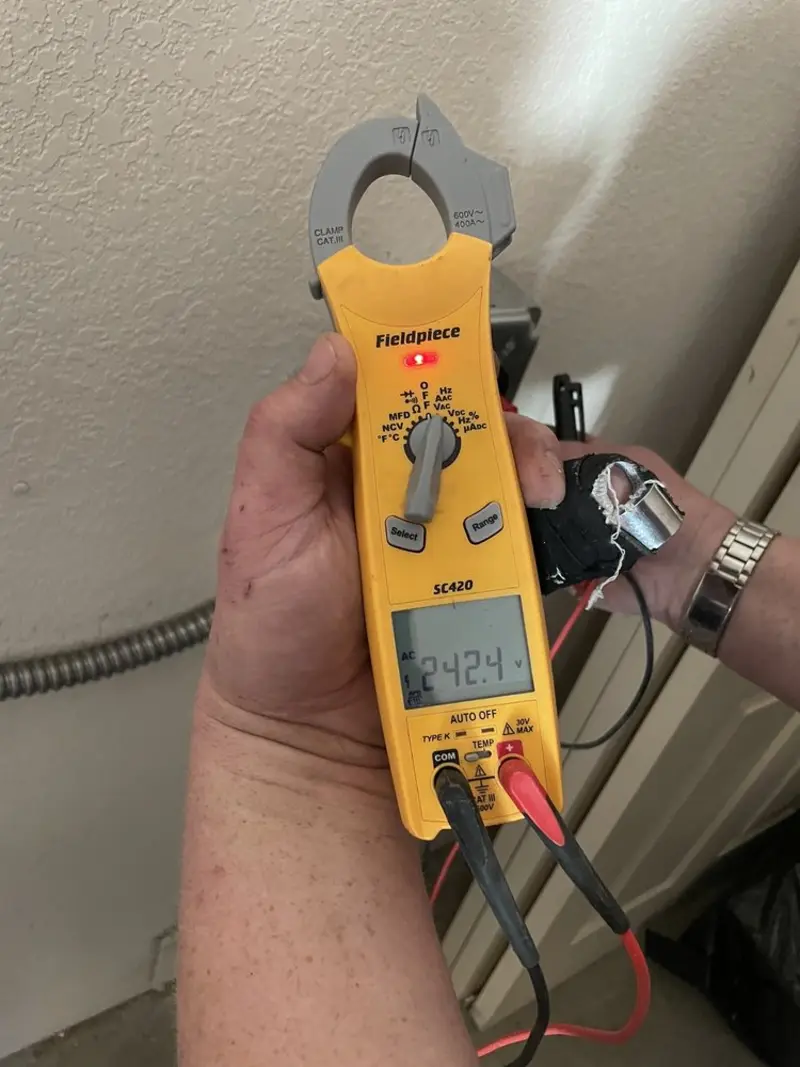 Voltage testing with clamp meter during Recessed Lighting Installation in Finley